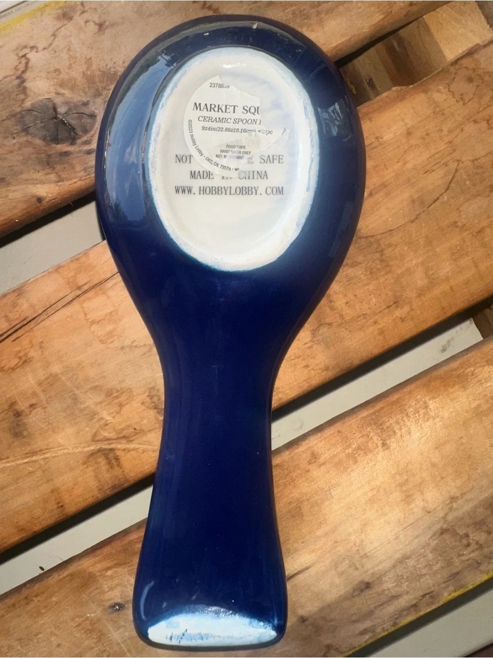 Ceramic spoon rest with a hand-painted blue and white floral pattern